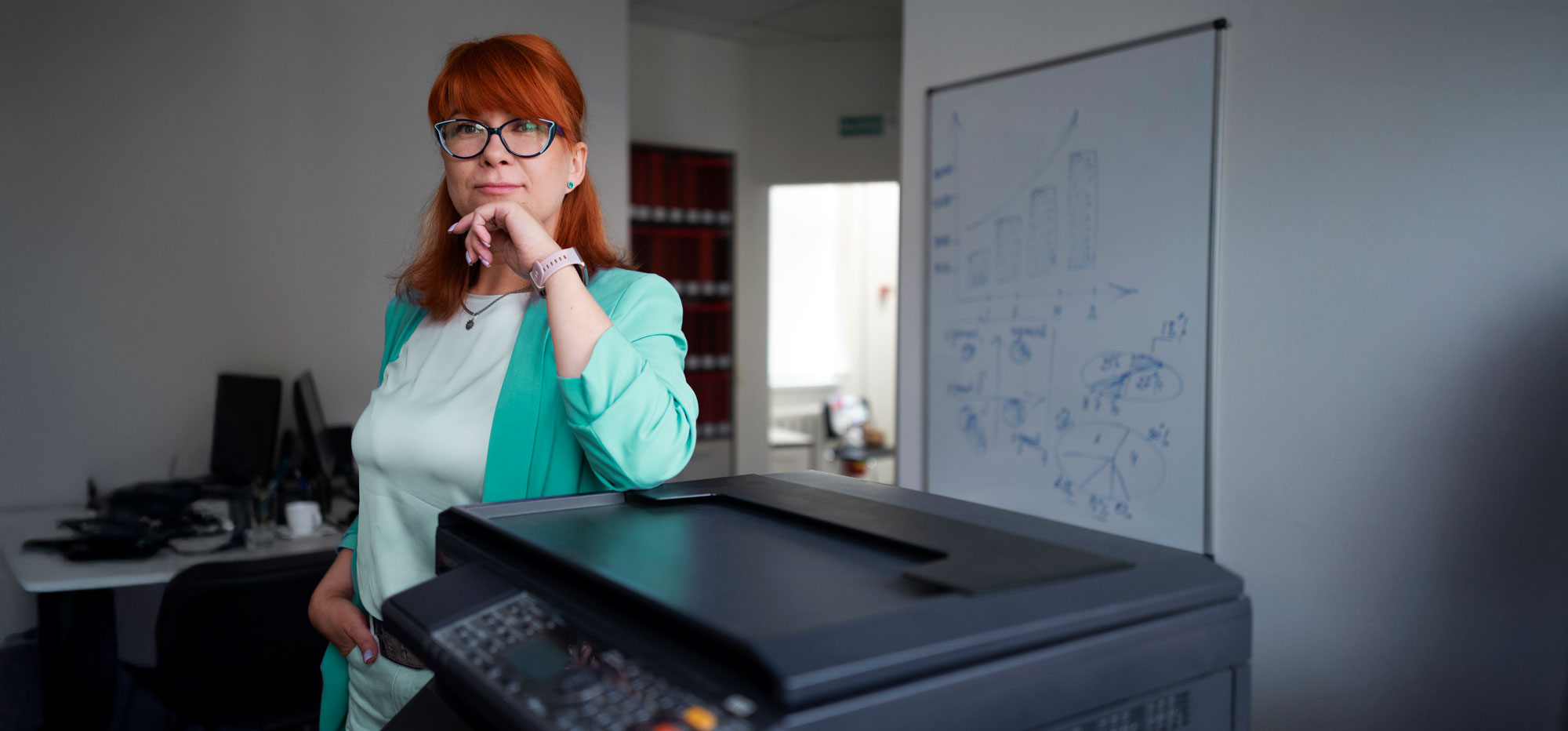 woman standing near printer holding looking at the camera